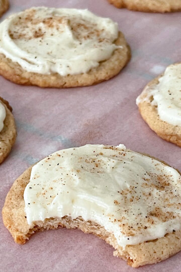 Eggnog cookies with eggnog frosting on parchment paper.