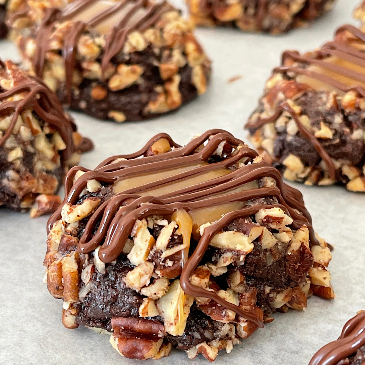 Turtle Thumbprint Cookies on parchment paper.