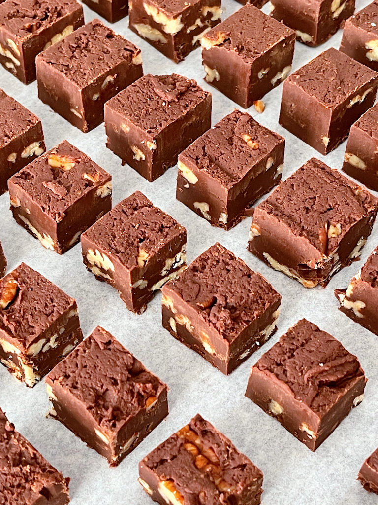 Fudge cut into pieces on parchment paper.