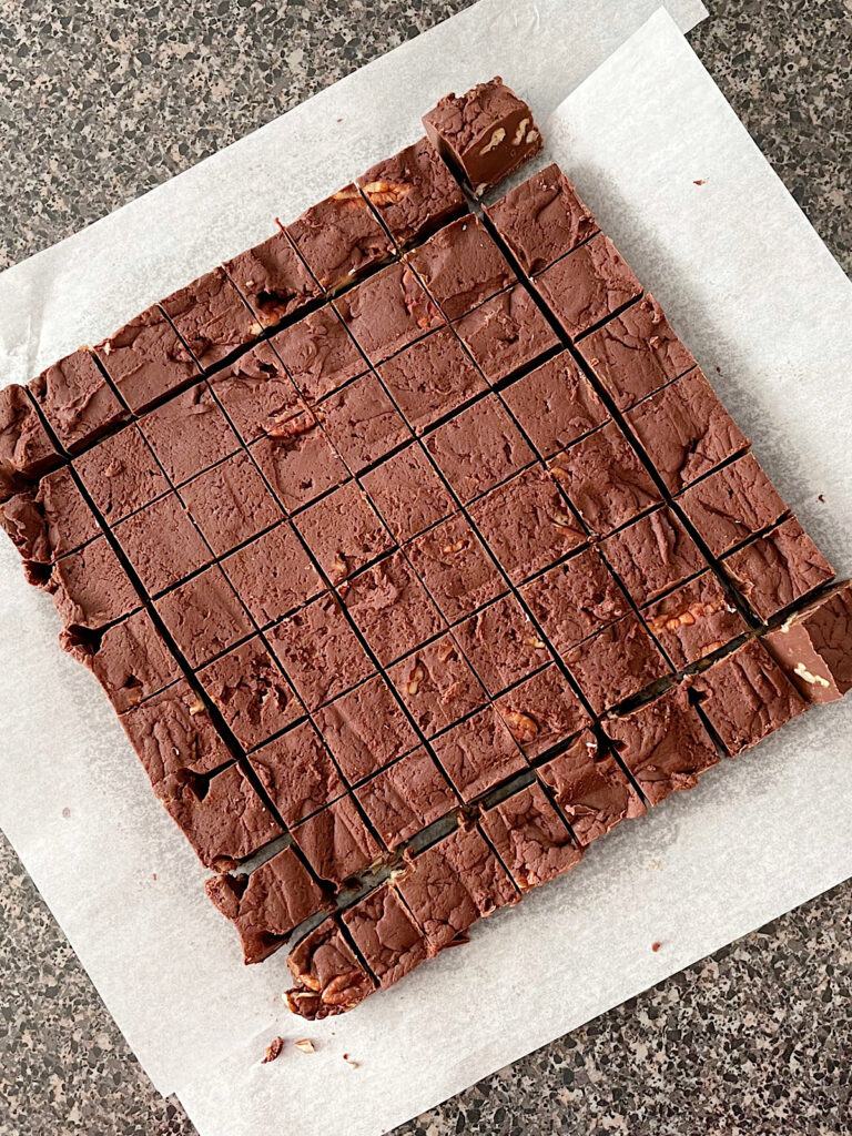 Fudge cut into pieces on parchment paper.