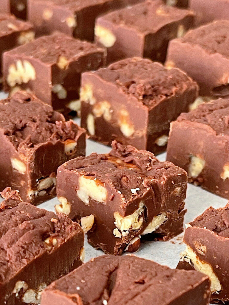 Fudge cut into pieces on parchment paper.