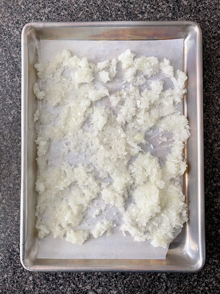 Diced onion on a baking sheet.