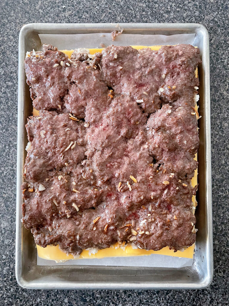 A large hamburger patty on dinner rolls.