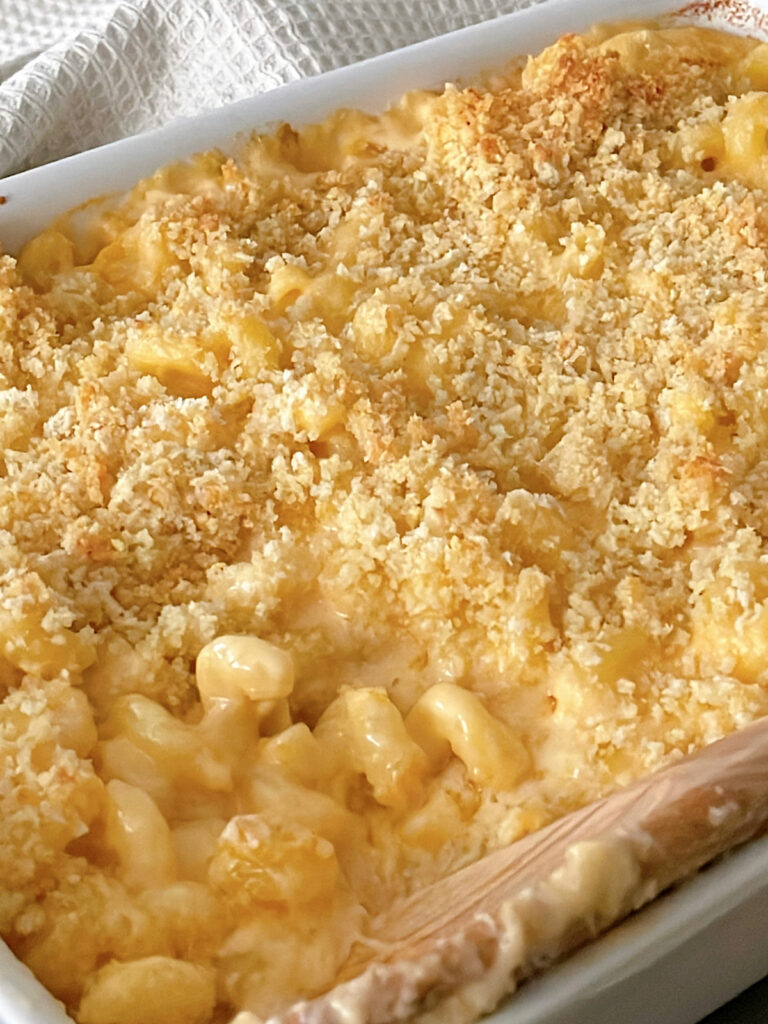 Baked mac and cheese in a white baking dish.