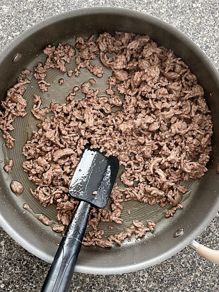 Ground beef in a skillet.