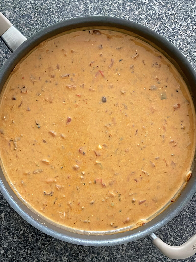 Cheesy enchilada chili in a large pan.