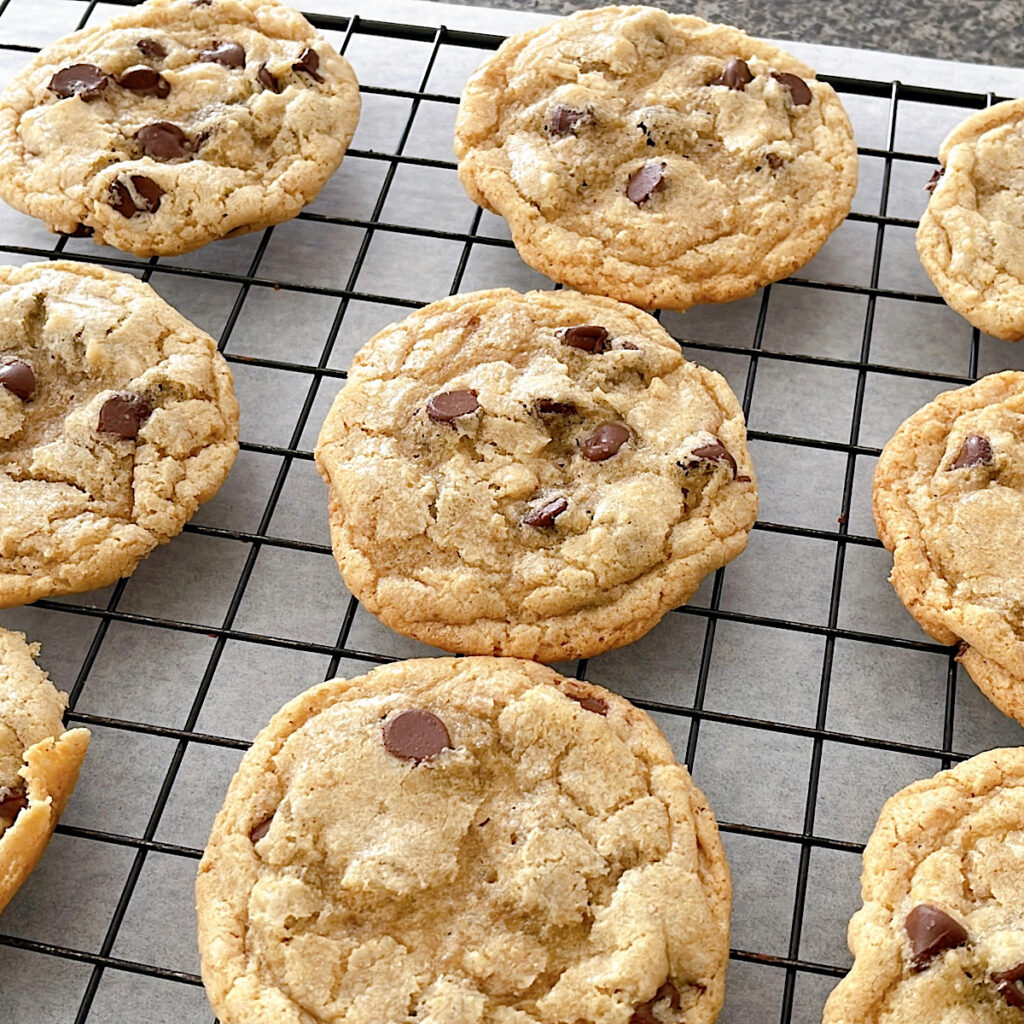 Sourdough chocolate chip cookies on a cooling rack.