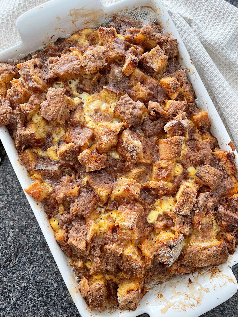 Cinnamon Crunch French Toast casserole in a white baking dish.