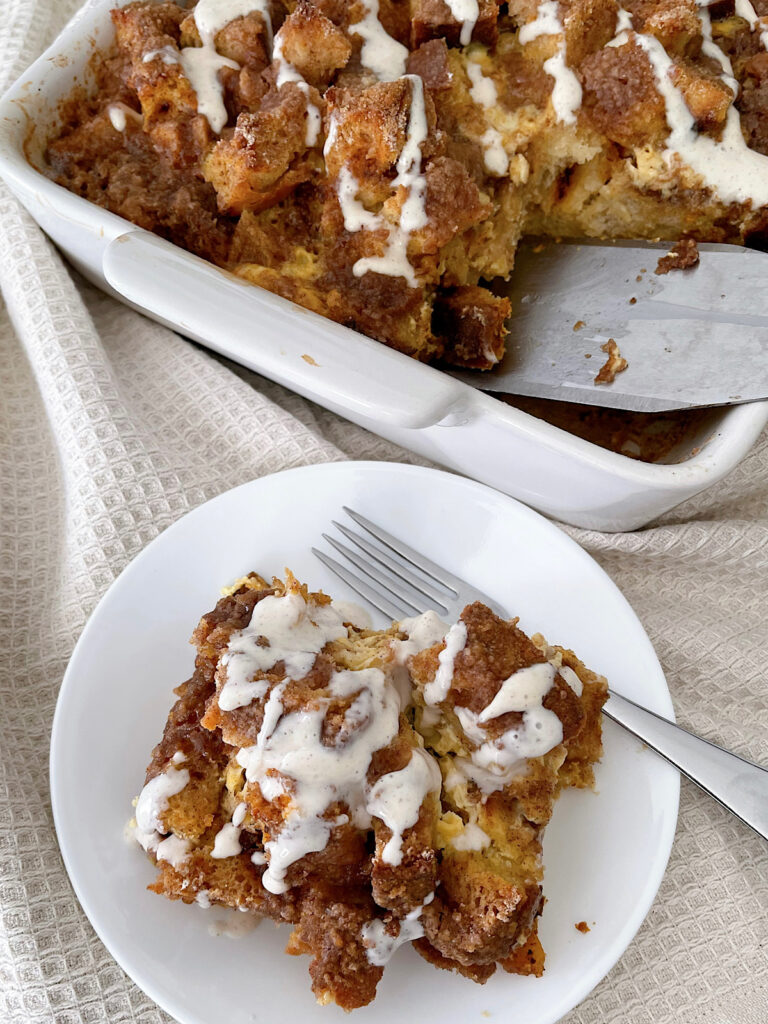A slice of cinnamon french toast casserole with cream cheese syrup.