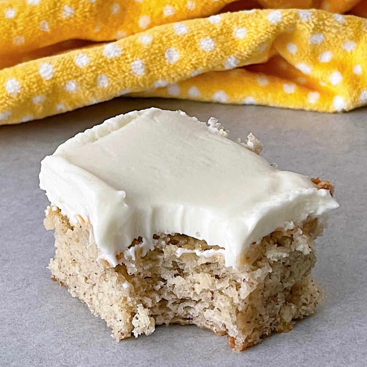 A banana bread bar with cream cheese frosting.
