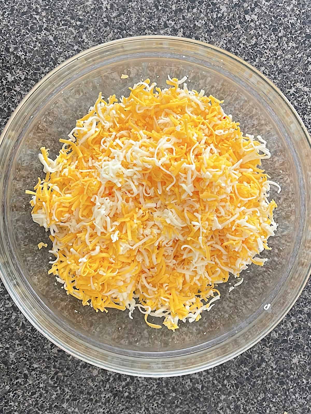 Shredded cheese in a bowl.