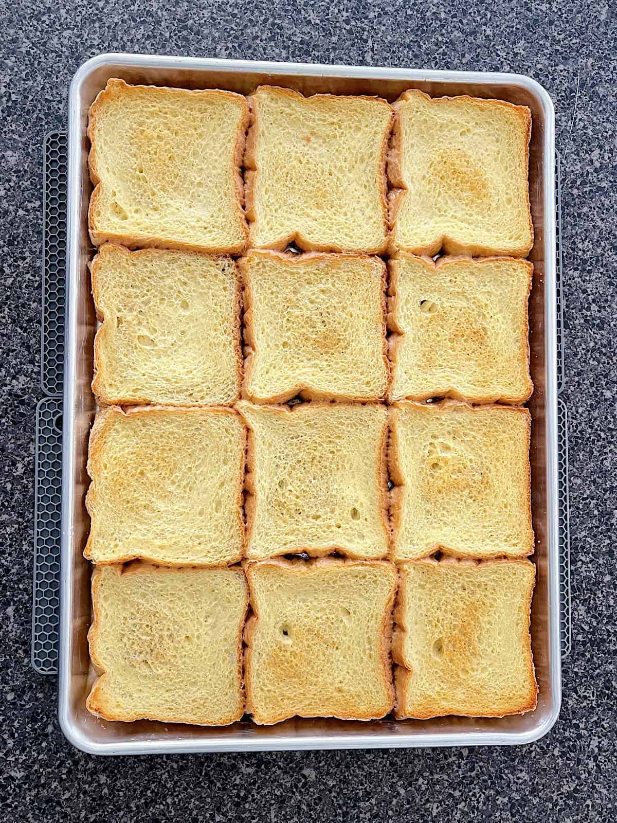 Crème Brûlée French Toast slices on a baking sheet.