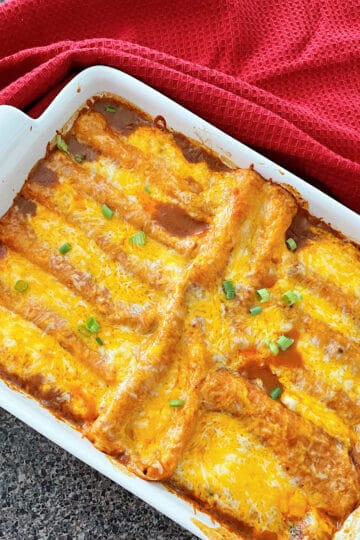 Restaurant-style cheese enchiladas in a white dish.