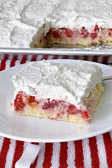 A slice of strawberry sheet cream cake.