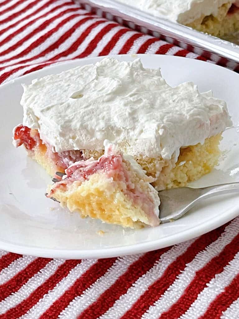 A slice of strawberry cream cake.