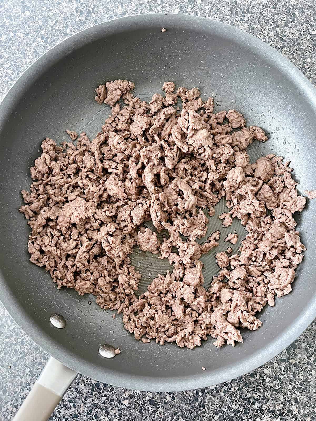 Ground beef in a large skillet.