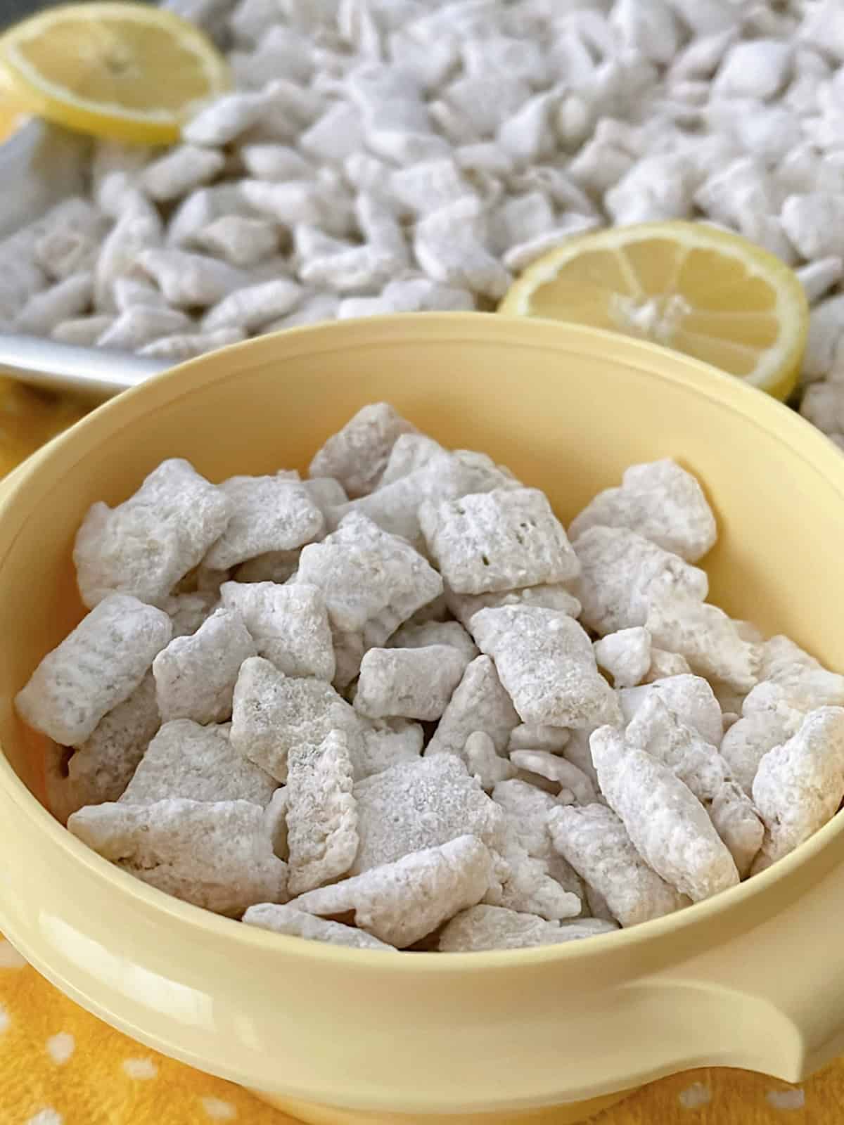 A yellow bowl full of lemon muddy buddies.
