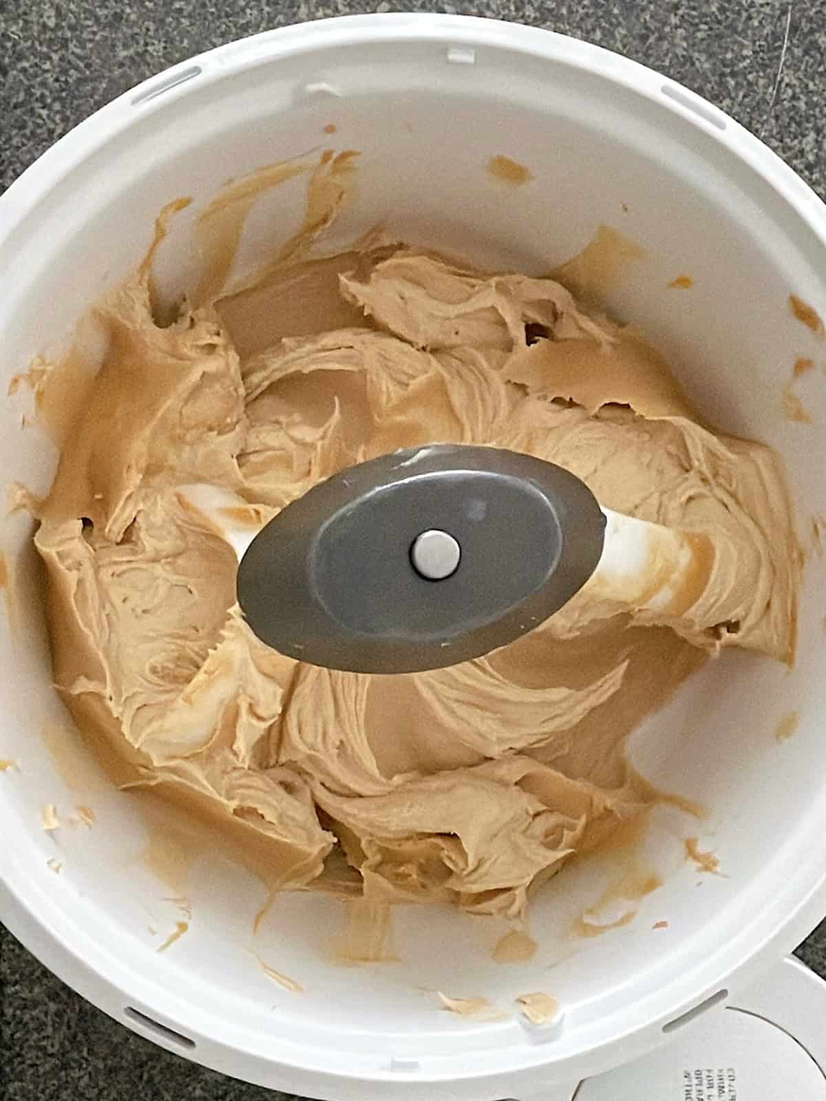 Butter, peanut butter, sugar and brown sugar mixed together in a bowl.