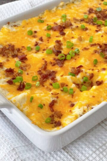 Twice Baked Potato Casserole in a white baking dish.