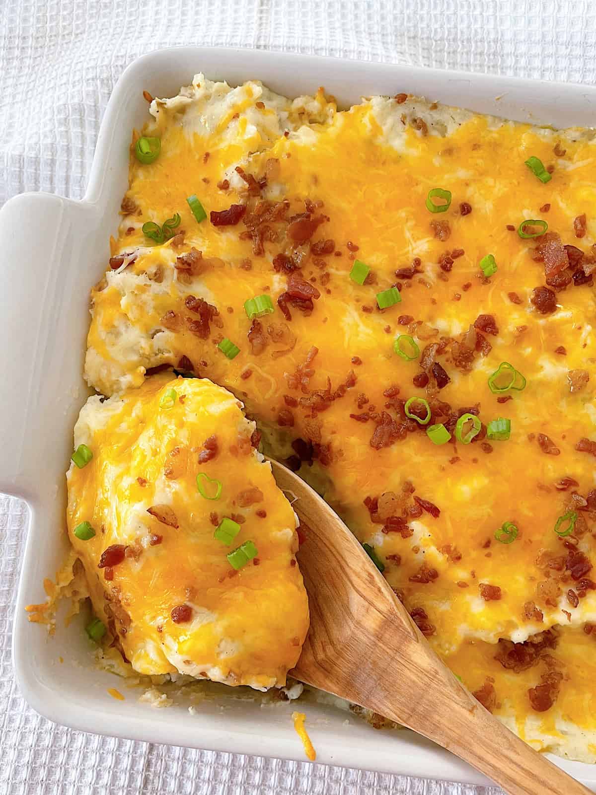Twice Baked Potato Casserole in a white baking dish.
