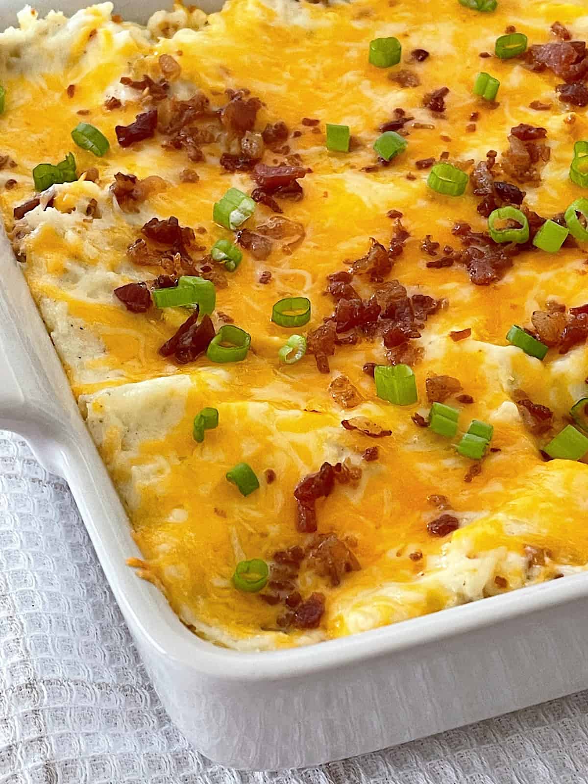 Twice Baked Potato Casserole in a white baking dish.