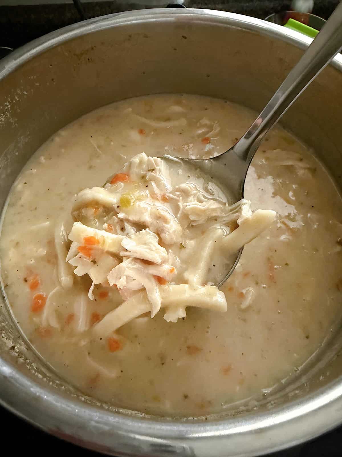 Creamy Chicken Noodle Soup in a ladle.