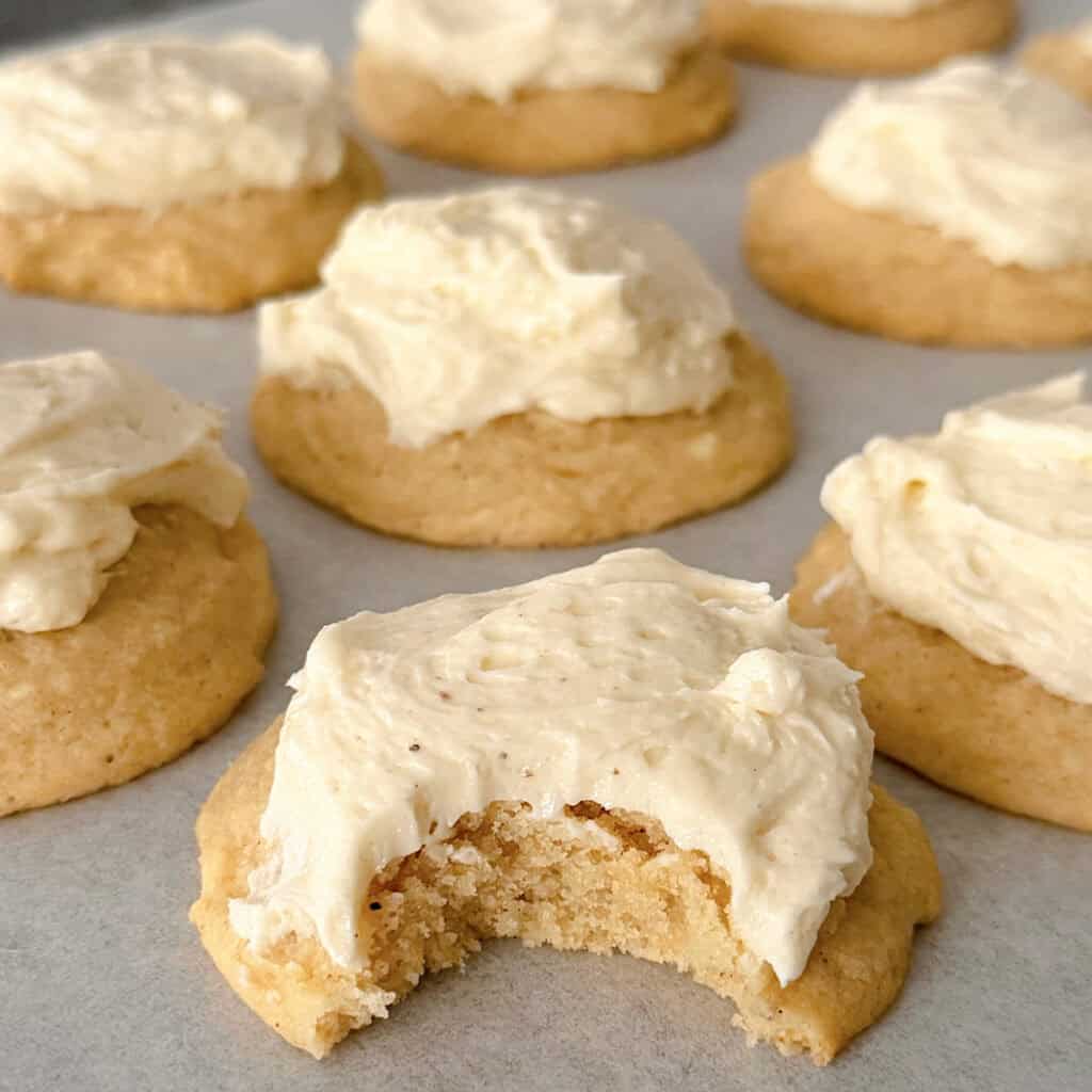 Eggnog cookies with eggnog frosting on a baking sheet.