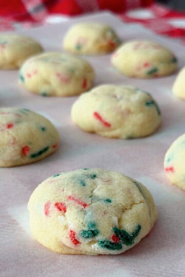 Christmas Sugardoodle Cookies on parchment paper with a Christmas plaid backgroun