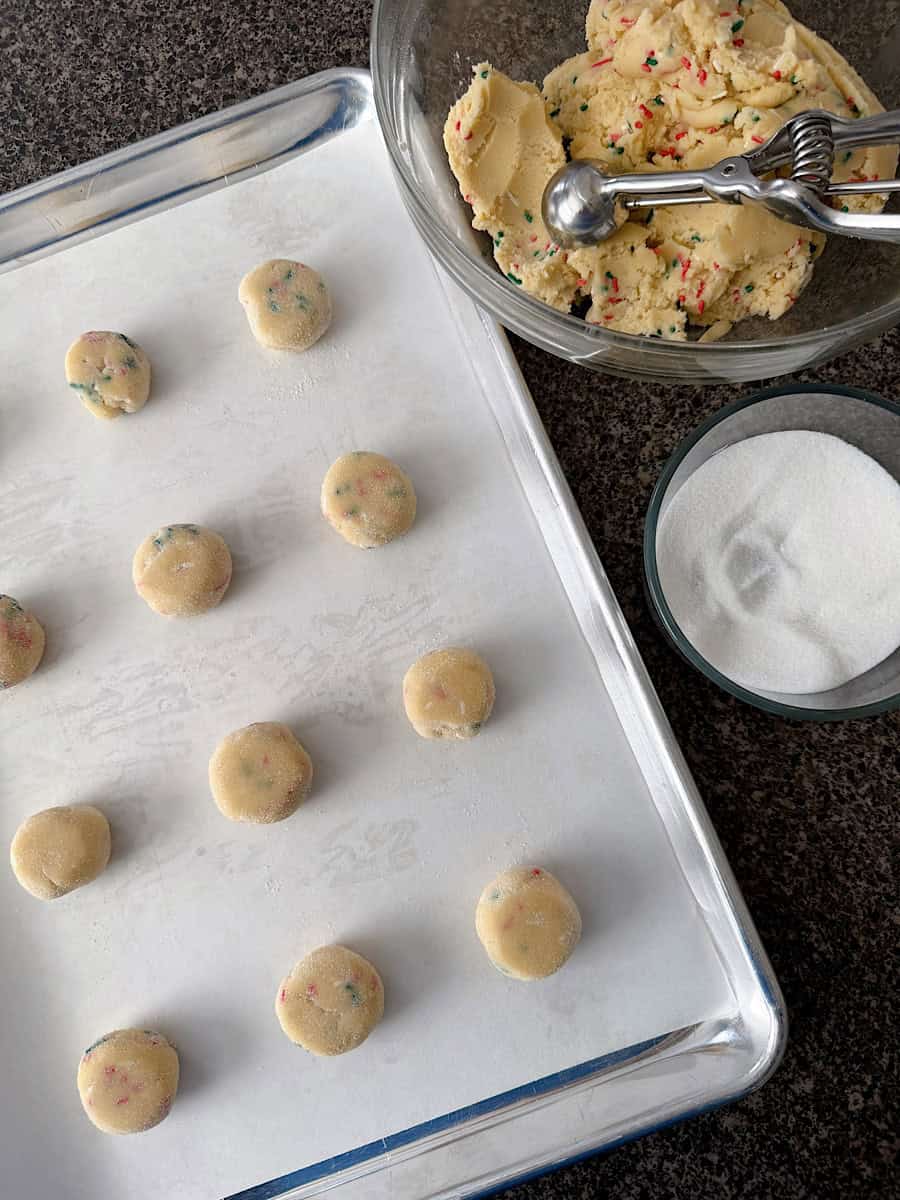 Sugardoodle cookie dough balls on a baking sheet.