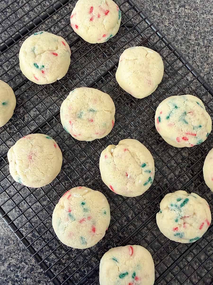 Christmas sugar cookies on a cooling rack.