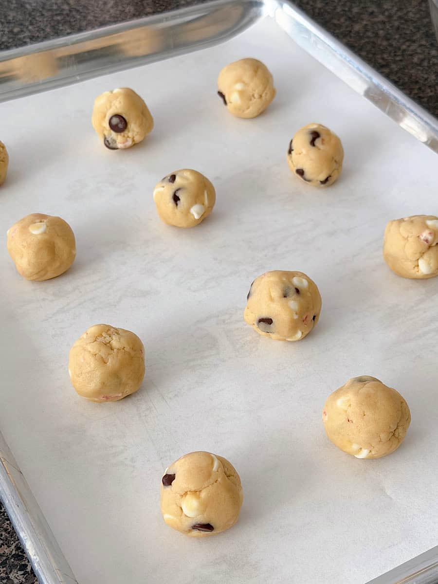Cookie dough balls on a baking sheet.
