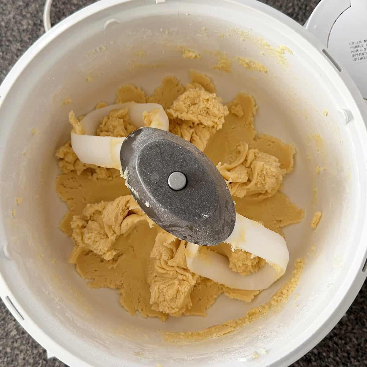 Sugar cookie dough in a stand mixer.