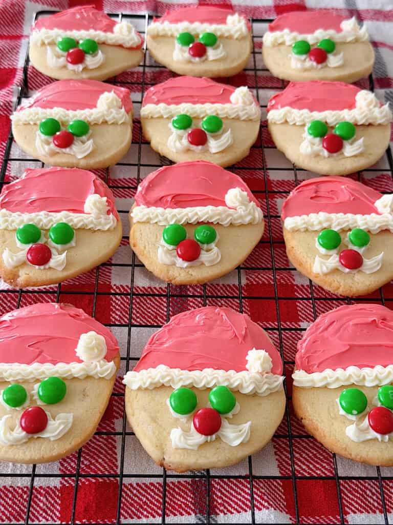 A round sugar cookie decorated to look like Santa.