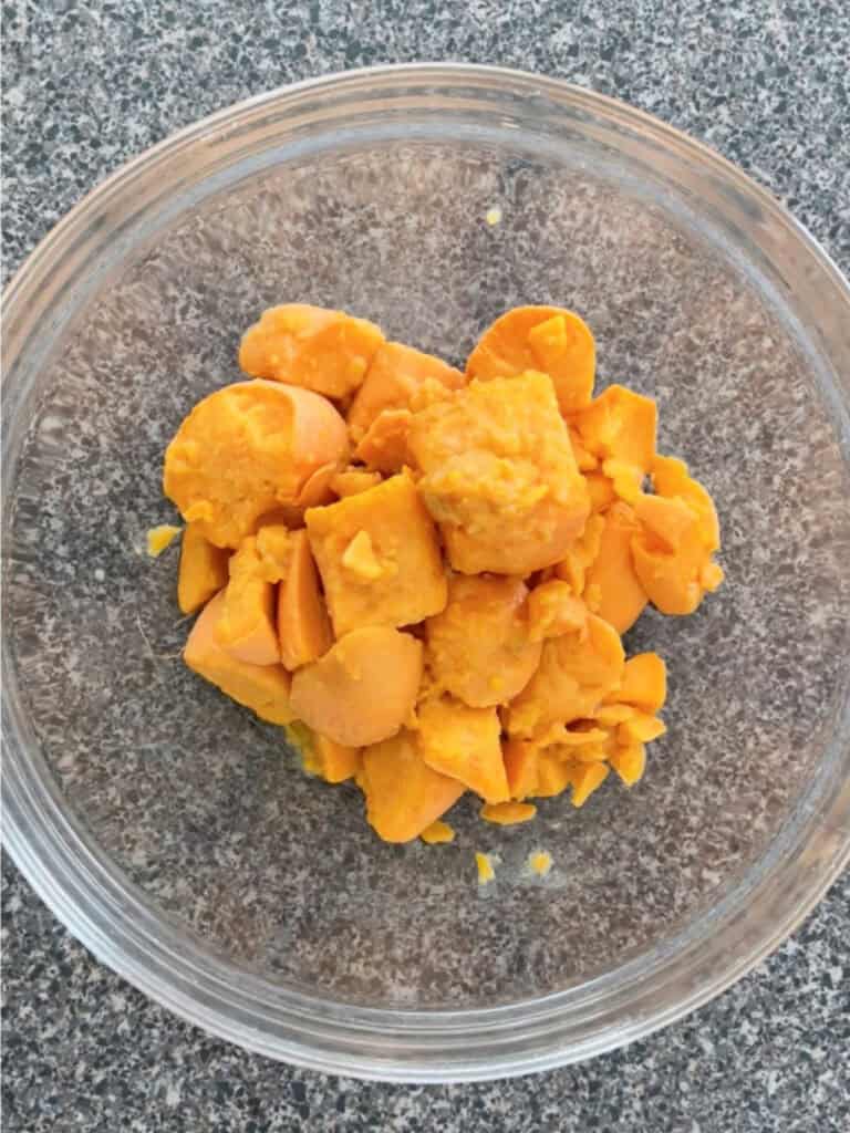 Diced and peeled yams in a clear bowl.